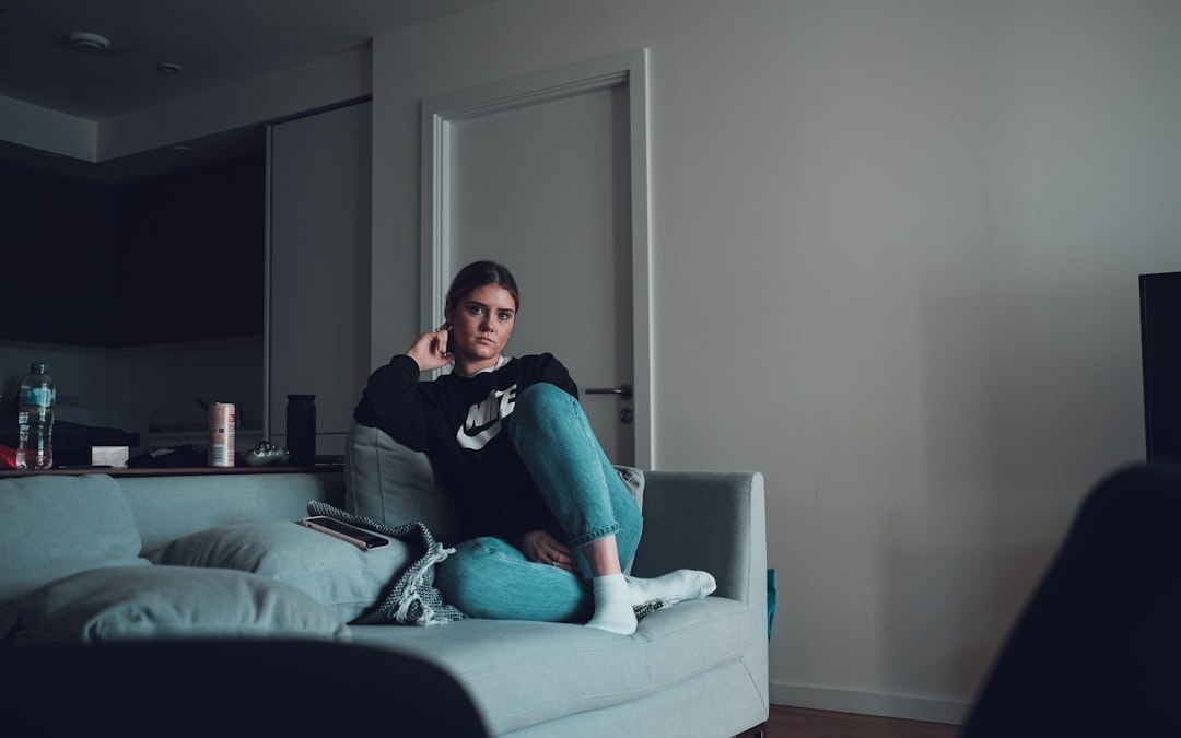 person relaxing on couch watching tv