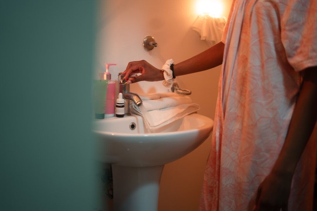 person brushing teeth in bathroom